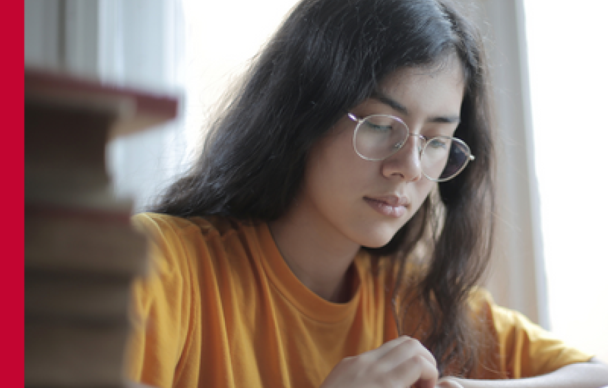 A female resenting student reads a book