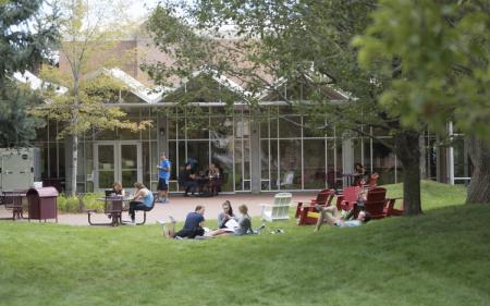photo of students sitting outside on campus