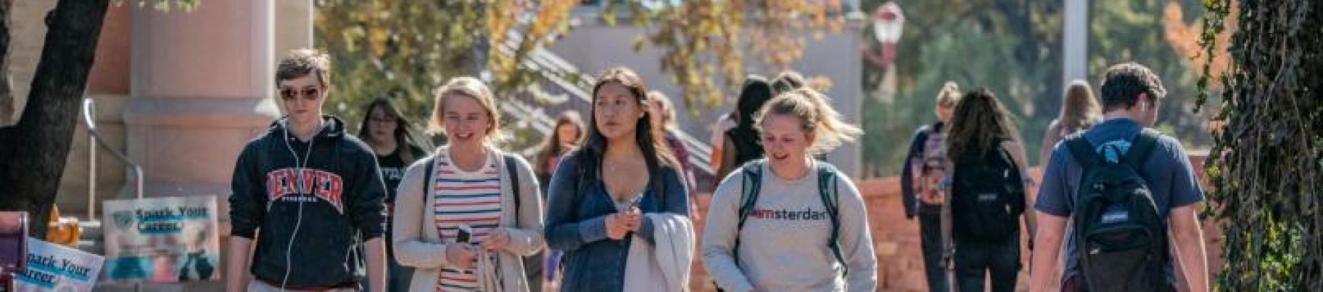 students walking across campus in fall term
